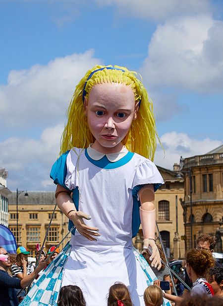 A giant puppet Alice in the streets of Oxford